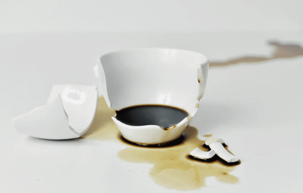 Broken mug symbolizing navigating grief and coping with loss